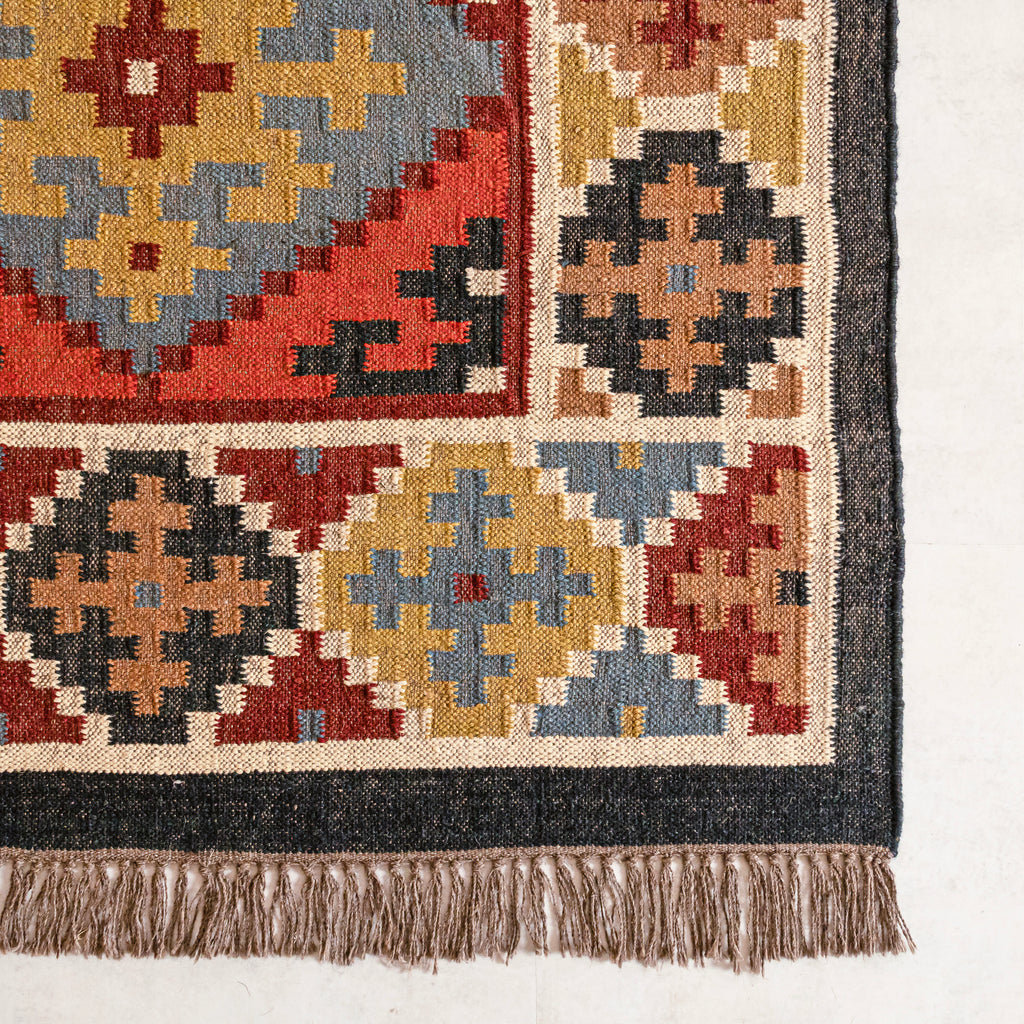 Close-up Jute Kilim rug with geometric designs on a white background