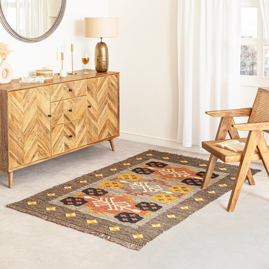 Wool Kilim Rug in Living room with wooden sideboard and chair.