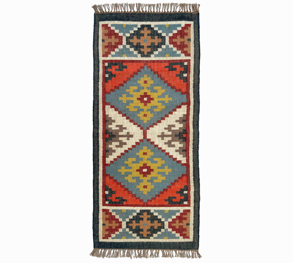 Woven kilim rug with geometric pattern on a white background