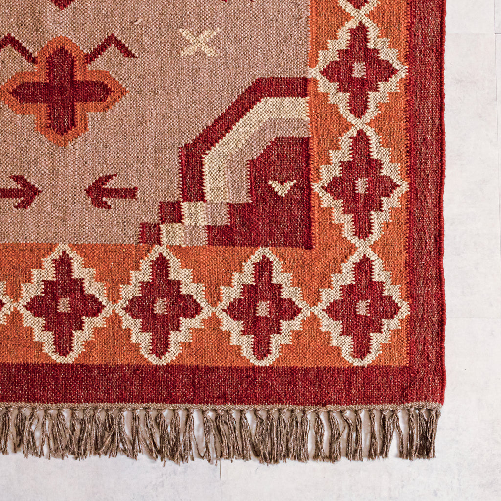 Close-up of a wool jute kilim  rug with geometric designs on a white background
