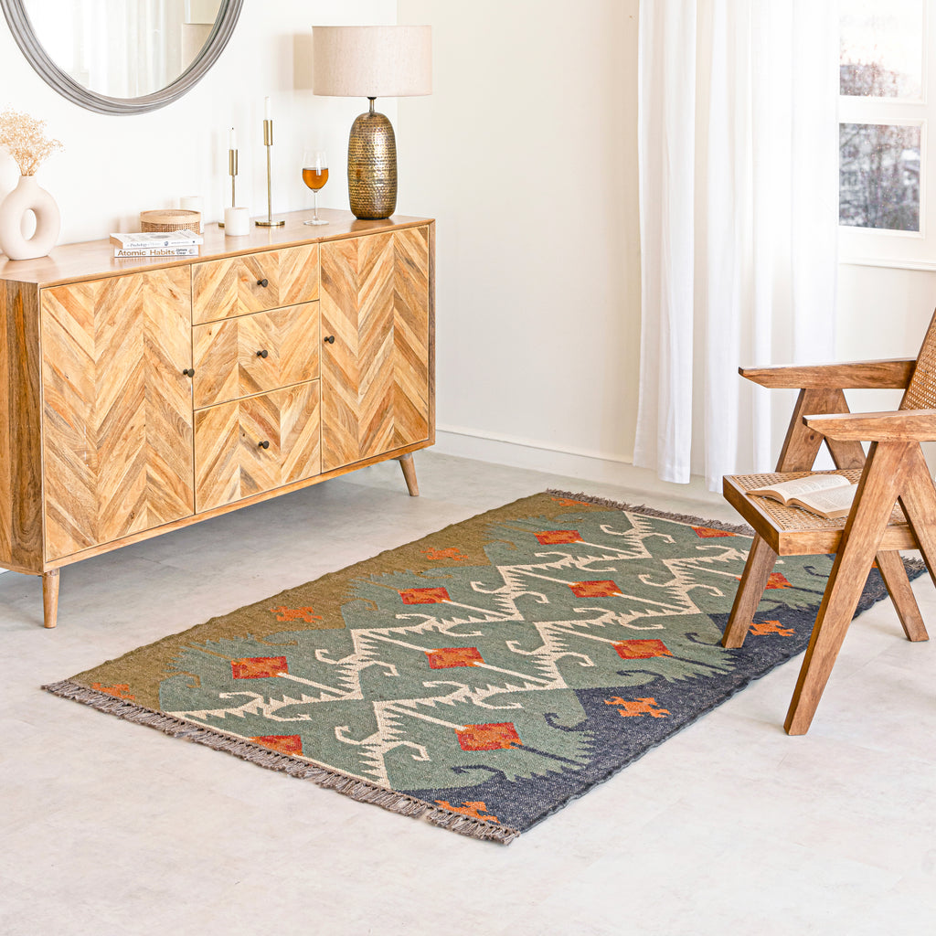 Jute Kilim Rug in Living room with wooden sideboard, table.