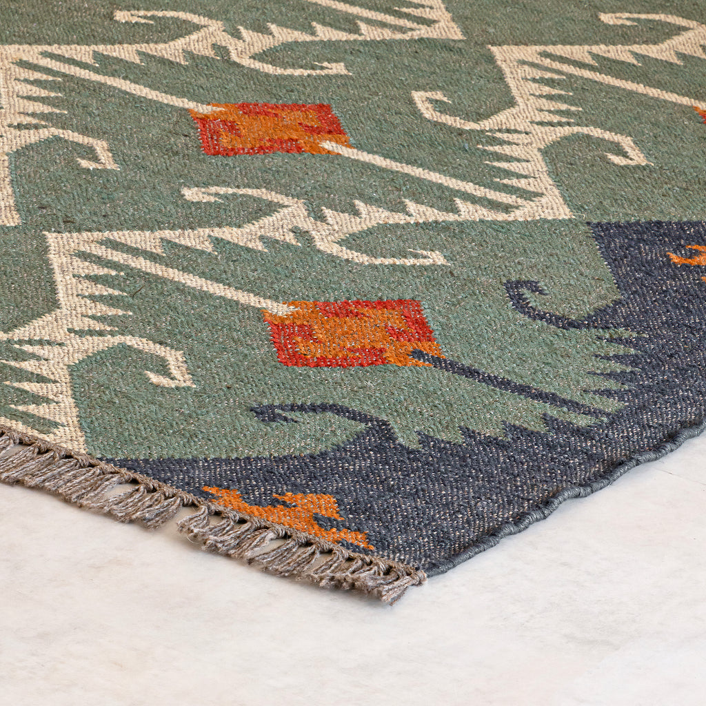 Close-up of a Kilim Jute rug with geometric design on a white background