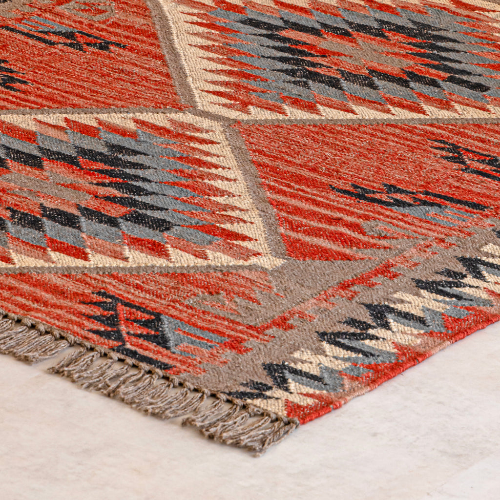 Close up of Jute Kilim rug with geometric design on a light background