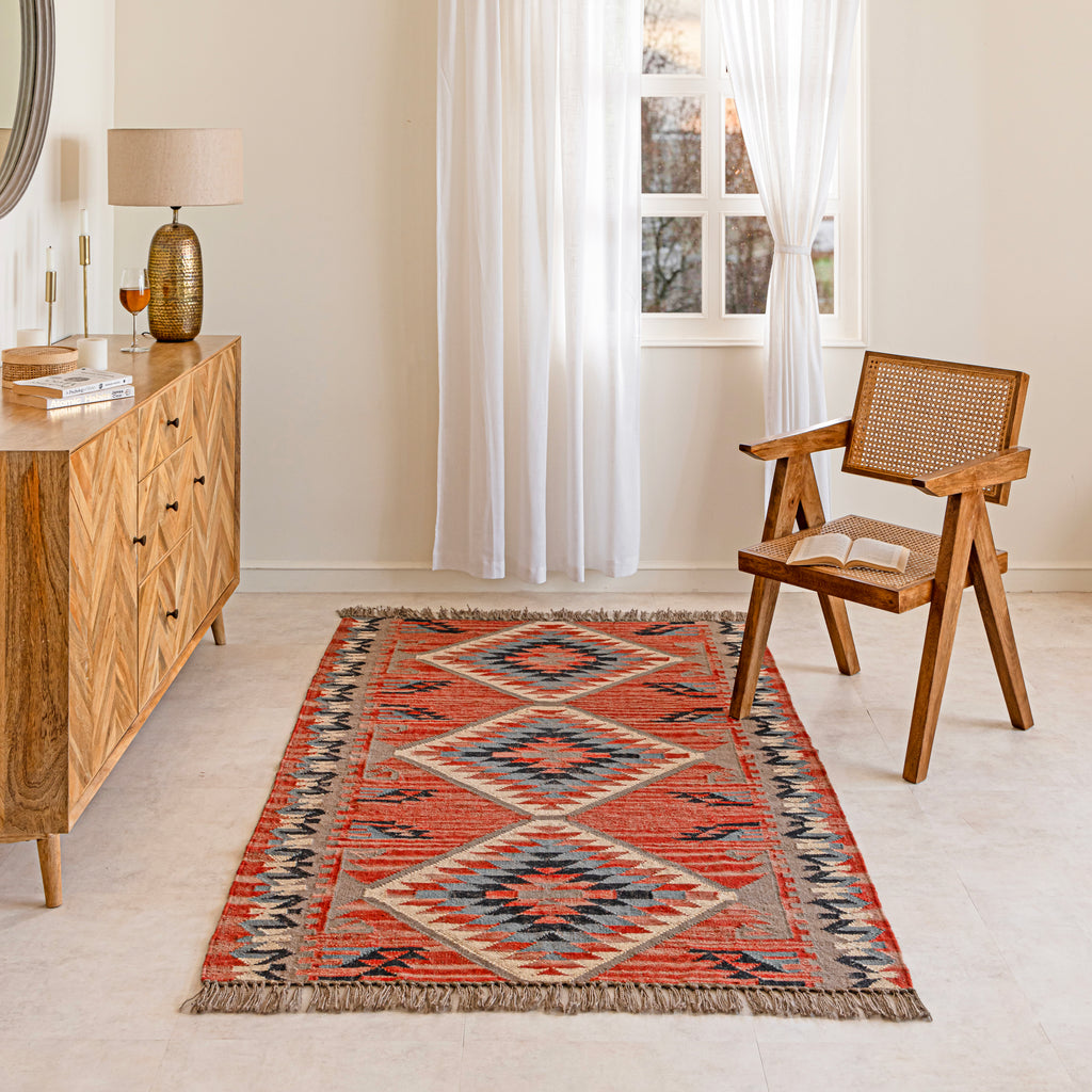 Jute Kilim Rug in Living room with a wooden chair, and sideboard.